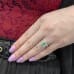 Oval Merelani Mint Garnet Swoop Halo Ring on ladies hand