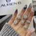 1.55 carat Round Lab Diamond Graduating Floral Engagement Ring hand