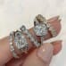 2.20 carat Asscher Cut Diamond Three-Stone Bezel Ring finger