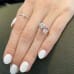 Oval Morganite and Cushion Moissanite Duo Ring profile view on ladies hand 
